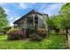 Back of the house featuring a deck and screen porch, with lush landscaping at 9310 Hunting Ct, Matthews, NC 28105