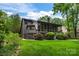 Back exterior view of the house showing the screened in porch and landscaping at 9310 Hunting Ct, Matthews, NC 28105