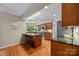 Open kitchen with granite countertops, hardwood floors, and stainless steel appliances at 9310 Hunting Ct, Matthews, NC 28105