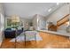 Bright living room with vaulted ceilings, hardwood floors, and a cozy seating area at 9310 Hunting Ct, Matthews, NC 28105