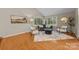 Bright living room with hardwood floors, large windows, and stylish decor at 9310 Hunting Ct, Matthews, NC 28105