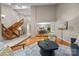 Spacious living room featuring hardwood floors, a staircase, and an open layout at 9310 Hunting Ct, Matthews, NC 28105