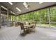 Bright sunroom with ceiling fans, skylights, and a wall of windows offering stunning views of the surrounding greenery at 9310 Hunting Ct, Matthews, NC 28105