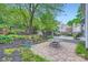 Landscaped backyard featuring a deck with seating area, a stone patio and garden at 9517 Harris Glen Dr, Charlotte, NC 28269