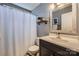 Cozy bathroom featuring a vanity with a decorative mirror and shelf with plants at 9517 Harris Glen Dr, Charlotte, NC 28269