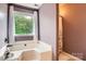 Bathroom showcasing an elegant soaking tub with a large window view at 9517 Harris Glen Dr, Charlotte, NC 28269