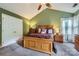 Bedroom features a pitched ceiling, carpet flooring, a ceiling fan, and natural light at 9517 Harris Glen Dr, Charlotte, NC 28269