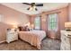 Cozy bedroom with carpet flooring, neutral walls, a ceiling fan, and bright windows at 9517 Harris Glen Dr, Charlotte, NC 28269