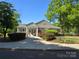 Charming clubhouse entrance with well-maintained landscaping and inviting walkway at 9517 Harris Glen Dr, Charlotte, NC 28269