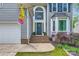 Inviting front entrance with a navy door, arched window, and landscaped garden at 9517 Harris Glen Dr, Charlotte, NC 28269