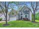 Charming home with a manicured lawn, showcasing curb appeal framed by mature trees at 9517 Harris Glen Dr, Charlotte, NC 28269