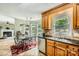 Bright kitchen with tile floors and a view into the breakfast nook with a fireplace at 9517 Harris Glen Dr, Charlotte, NC 28269