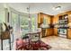 Eat-in kitchen features stainless steel appliances, wooden cabinets, breakfast nook with large window views at 9517 Harris Glen Dr, Charlotte, NC 28269
