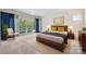Bright bedroom featuring a king bed, water view, and balcony access at 102 Eastham Ct, Mooresville, NC 28117