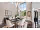 Formal dining room with elegant chandelier, modern decor, and large windows at 102 Eastham Ct, Mooresville, NC 28117