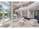 Grand foyer with spiral staircase, soaring ceilings, and elegant finishes leading to lake view at 102 Eastham Ct, Mooresville, NC 28117