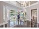 Grand foyer with spiral staircase, soaring ceilings, and elegant chandelier lighting at 102 Eastham Ct, Mooresville, NC 28117