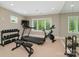 Home gym equipped with a treadmill, bike, weights, and a large mirror at 102 Eastham Ct, Mooresville, NC 28117