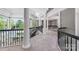 Elegant hallway featuring grand columns and a curved black iron railing at 102 Eastham Ct, Mooresville, NC 28117