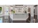 Bright kitchen showcasing a marble breakfast bar with plants and an orchid at 102 Eastham Ct, Mooresville, NC 28117