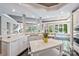 Spacious white kitchen with marble countertops, modern appliances, and a lake view at 102 Eastham Ct, Mooresville, NC 28117