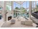 Sunlit living room features a fireplace, spiral staircase, and panoramic views of the lake at 102 Eastham Ct, Mooresville, NC 28117