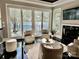 Cozy living room boasts lake views, a fireplace, and sliding doors to outdoor balcony at 102 Eastham Ct, Mooresville, NC 28117