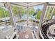 Open-concept living room with floor-to-ceiling windows and view of manicured lawn at 102 Eastham Ct, Mooresville, NC 28117