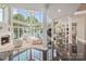 Bright living room with soaring ceilings, a fireplace, and lake views through expansive windows at 102 Eastham Ct, Mooresville, NC 28117