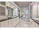 Main bathroom featuring marble floors, dual vanities, and a soaking tub at 102 Eastham Ct, Mooresville, NC 28117