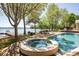 Beautiful pool and spa area overlooking the lake with lush landscaping and a serene outdoor space at 102 Eastham Ct, Mooresville, NC 28117