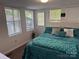 Cozy bedroom featuring a comfortable bed, natural light, and a welcoming ambiance at 104 Powder Horn Trl # C92, Mount Gilead, NC 27306