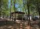 Park model home with covered parking near wooded backyard and storage shed at 104 Powder Horn Trl # C92, Mount Gilead, NC 27306