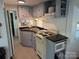 Well-equipped kitchen featuring a compact oven, microwave, and ample cabinet space at 104 Powder Horn Trl # C92, Mount Gilead, NC 27306