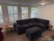 Cozy living room featuring a large sectional sofa and ample natural light from multiple windows at 104 Powder Horn Trl # C92, Mount Gilead, NC 27306