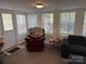 Inviting living room with a comfortable recliner, cozy blanket, and plenty of natural light from the windows at 104 Powder Horn Trl # C92, Mount Gilead, NC 27306