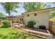 Expansive backyard with a wooden deck, stone patio, and well-maintained lawn at 1043 Nancy Dr, Charlotte, NC 28211
