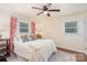 Cozy bedroom features a comfortable bed with decorative pillows and a patterned area rug at 1043 Nancy Dr, Charlotte, NC 28211