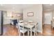 Open dining room featuring hardwood floors, white walls, and easy access to kitchen and front door at 1043 Nancy Dr, Charlotte, NC 28211