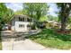 Exterior of a beautiful home featuring mature trees, a well-maintained lawn, and a paved driveway at 1043 Nancy Dr, Charlotte, NC 28211