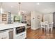 Bright kitchen with stainless steel appliances, granite countertops, and open layout to the living room and dining area at 1043 Nancy Dr, Charlotte, NC 28211