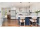 Modern kitchen featuring white cabinets, quartz countertops, stainless steel appliances, and a navy blue island at 1043 Nancy Dr, Charlotte, NC 28211