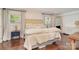 Spacious main bedroom featuring hardwood floors, brick accent wall, and abundant natural light at 1043 Nancy Dr, Charlotte, NC 28211