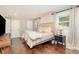 Comfortable main bedroom offering hardwood floors, ample closet space, and brick accent wall at 1043 Nancy Dr, Charlotte, NC 28211