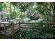 Secluded backyard with shed, trees, and decorative split rail fencing, offering a private outdoor living space at 10708 Danesway Ln, Cornelius, NC 28031