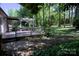 Wooded backyard with outdoor deck featuring privacy and shade provided by the surrounding trees at 10708 Danesway Ln, Cornelius, NC 28031
