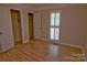 Light-filled bedroom with plantation shutters, closet space and hardwood floors at 10708 Danesway Ln, Cornelius, NC 28031