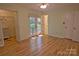 Spacious bedroom showcasing an ensuite bathroom and access to an outdoor porch area through glass paneled double doors at 10708 Danesway Ln, Cornelius, NC 28031