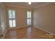 Inviting bedroom with plantation shutters, modern ceiling fan, and wood flooring at 10708 Danesway Ln, Cornelius, NC 28031