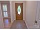 Entryway showcasing a decorative front door and tile floors, leading into a warm and inviting home interior at 10708 Danesway Ln, Cornelius, NC 28031